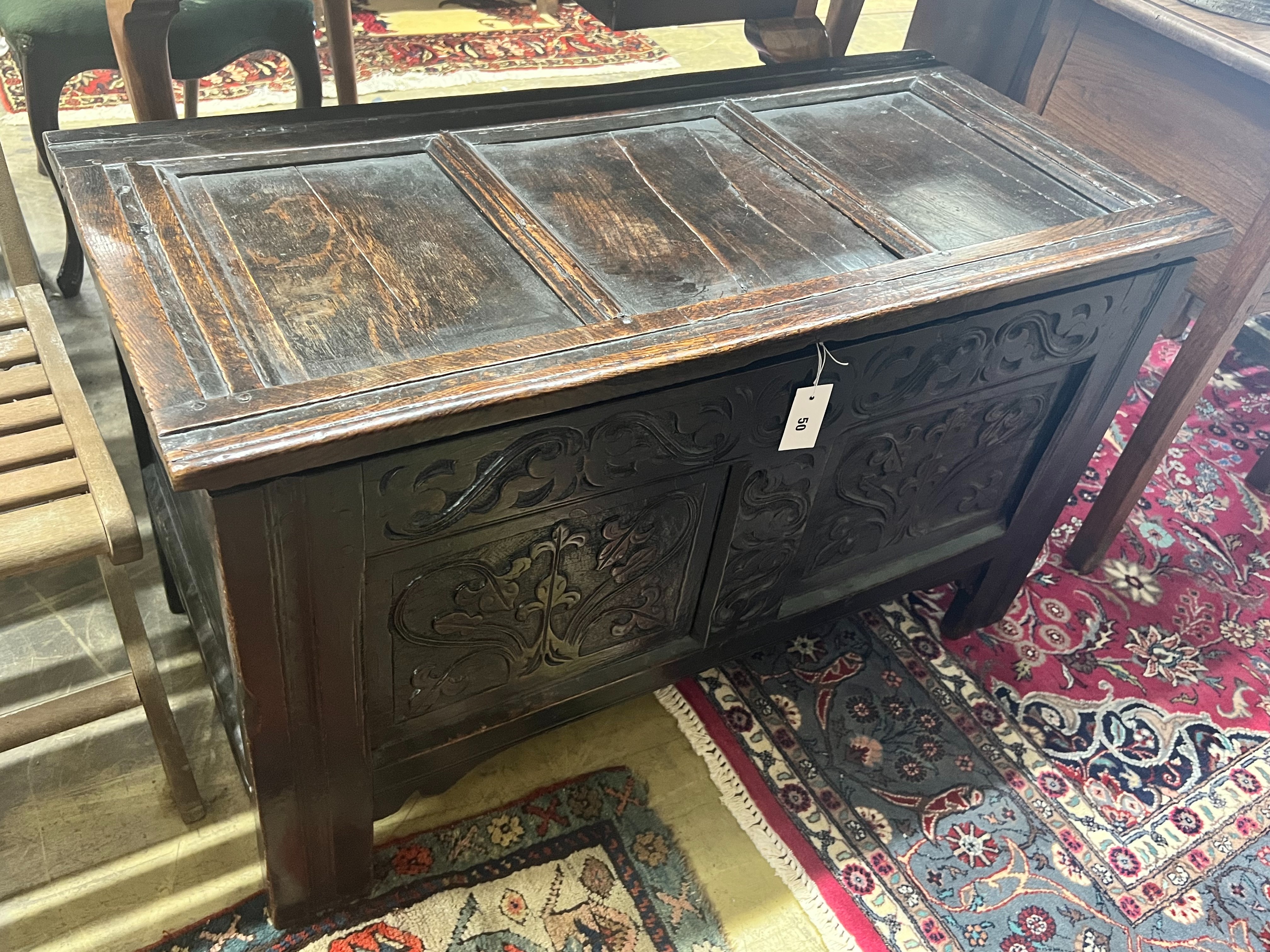 An 17th / 18th century oak coffer, with carved twin panelled front, width 103cm depth 50cm height 61cm